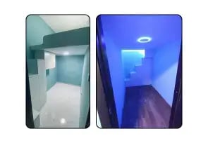 A narrow partition room with blue neon light.