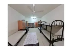 Sharing Bed Space in Al Rigga with two bunk beds and three single beds.