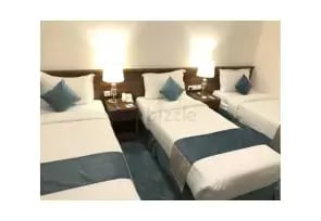 Three single beds next to each other in Al Rigga