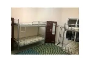 A sharing room with two bunk beds heading to each other.